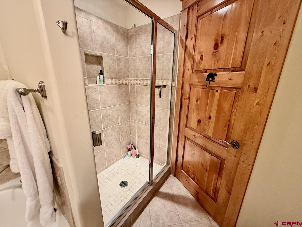 9 Hunter Hill Road, Unit 104 Crested Butte, CO 81225 - Photo 17 of 38 a bathroom with a tub a sink and a shower