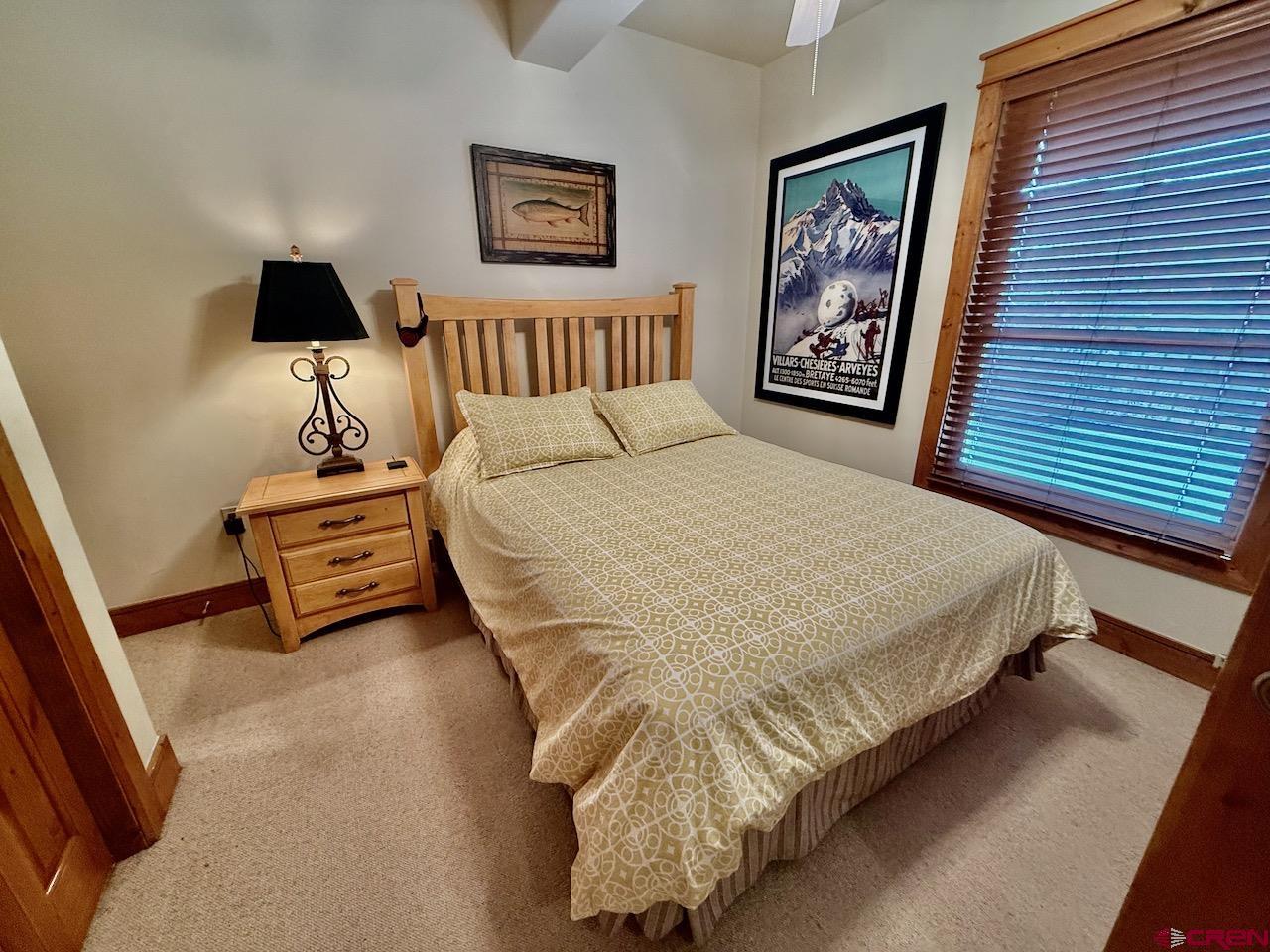 9 Hunter Hill Road, Unit 104 Crested Butte, CO 81225 - Photo 18 of 38 a bedroom with a bed and a wall painting