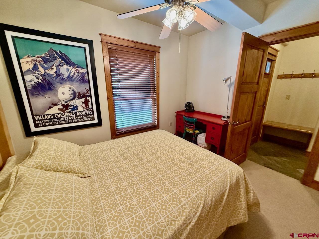 9 Hunter Hill Road, Unit 104 Crested Butte, CO 81225 - Photo 19 of 38 a bedroom with a bed and a painting on the wall