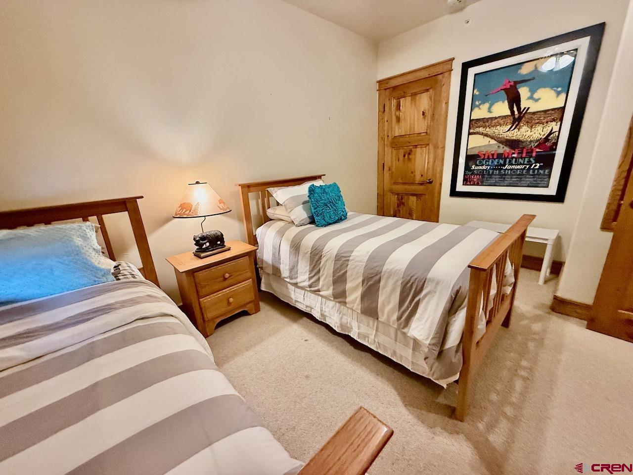 9 Hunter Hill Road, Unit 104 Crested Butte, CO 81225 - Photo 21 of 38 a bedroom with bed and wall painting