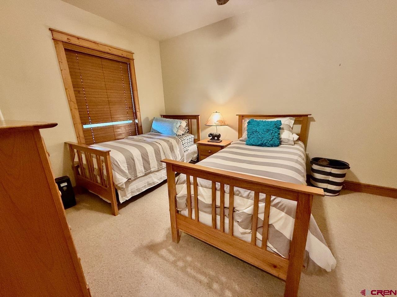 9 Hunter Hill Road, Unit 104 Crested Butte, CO 81225 - Photo 22 of 38 a bedroom with a bed and a window