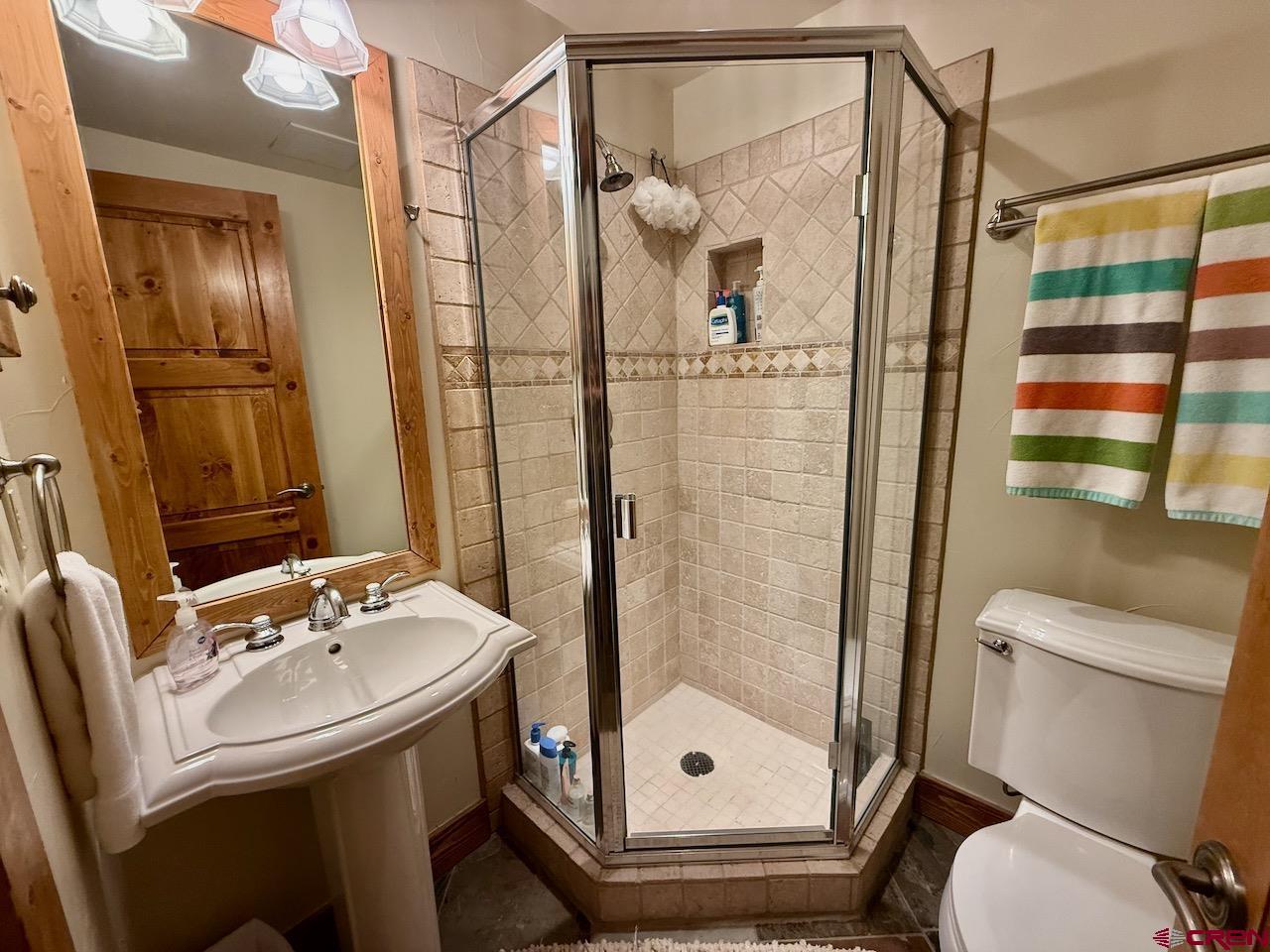 9 Hunter Hill Road, Unit 104 Crested Butte, CO 81225 - Photo 23 of 38 a bathroom with a shower a toilet and a sink