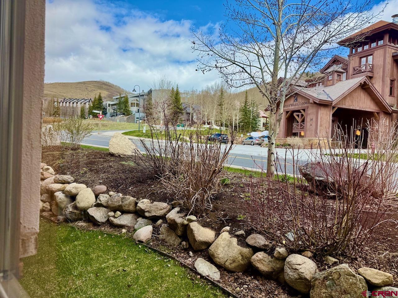 9 Hunter Hill Road, Unit 104 Crested Butte, CO 81225 - Photo 25 of 38 a view of a house with a yard and garden
