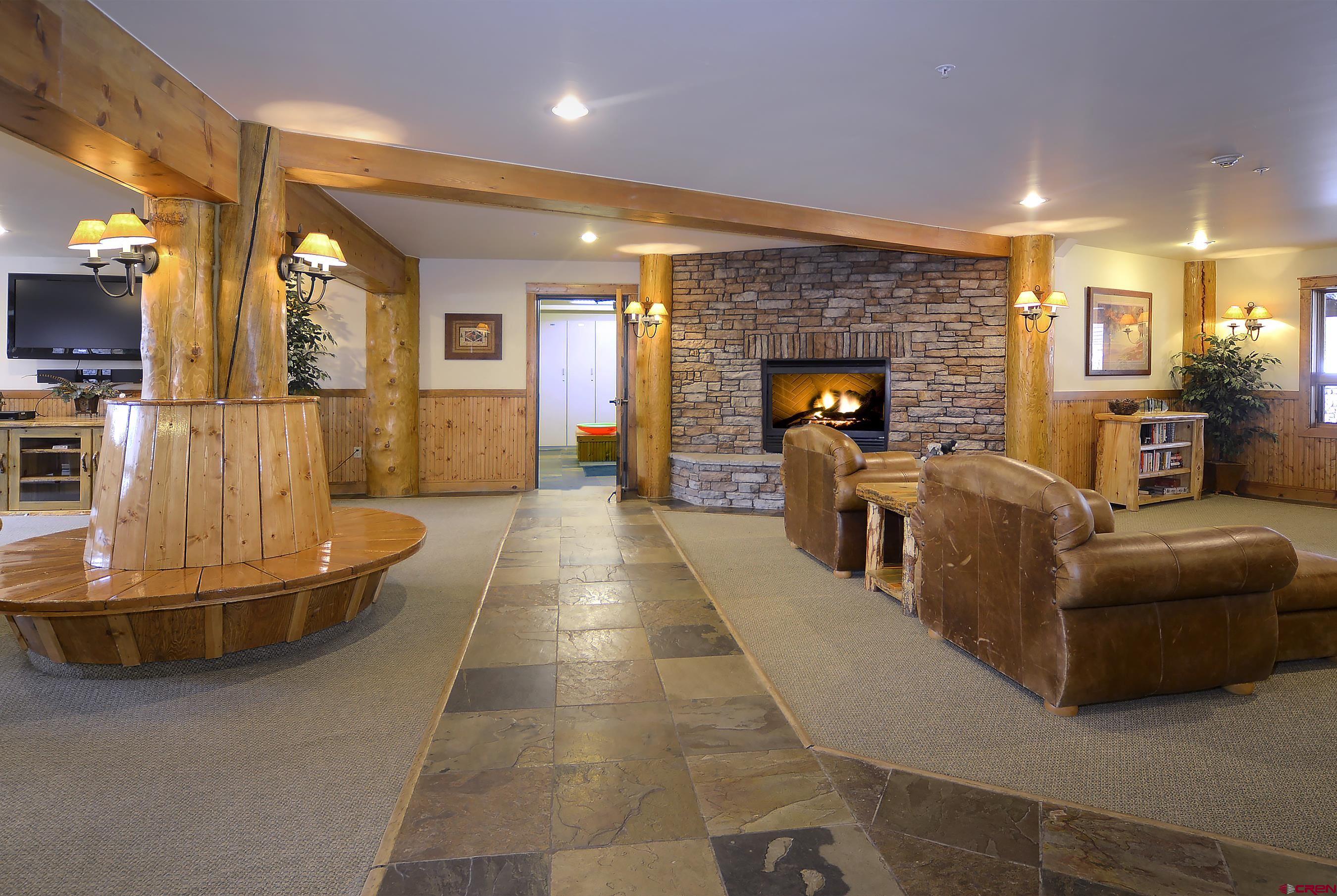 9 Hunter Hill Road, Unit 104 Crested Butte, CO 81225 - Photo 30 of 38 a living room with furniture and a fireplace