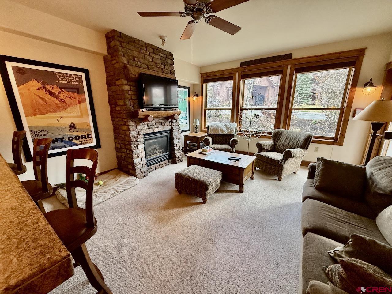 9 Hunter Hill Road, Unit 104 Crested Butte, CO 81225 - Photo 4 of 38 a living room with furniture and a flat screen tv