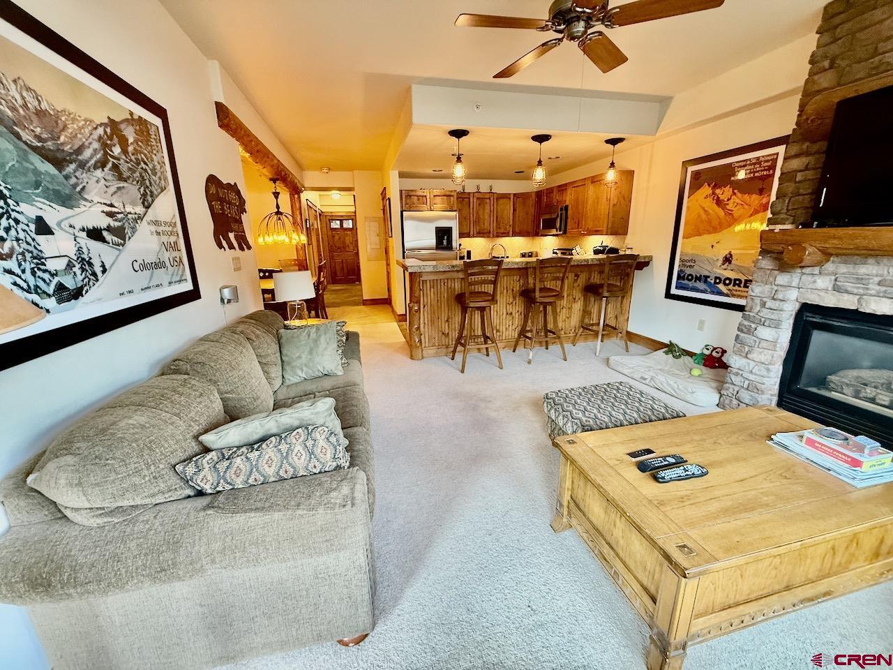 9 Hunter Hill Road, Unit 104 Crested Butte, CO 81225 - Photo 5 of 38 a living room with furniture and flat screen tv