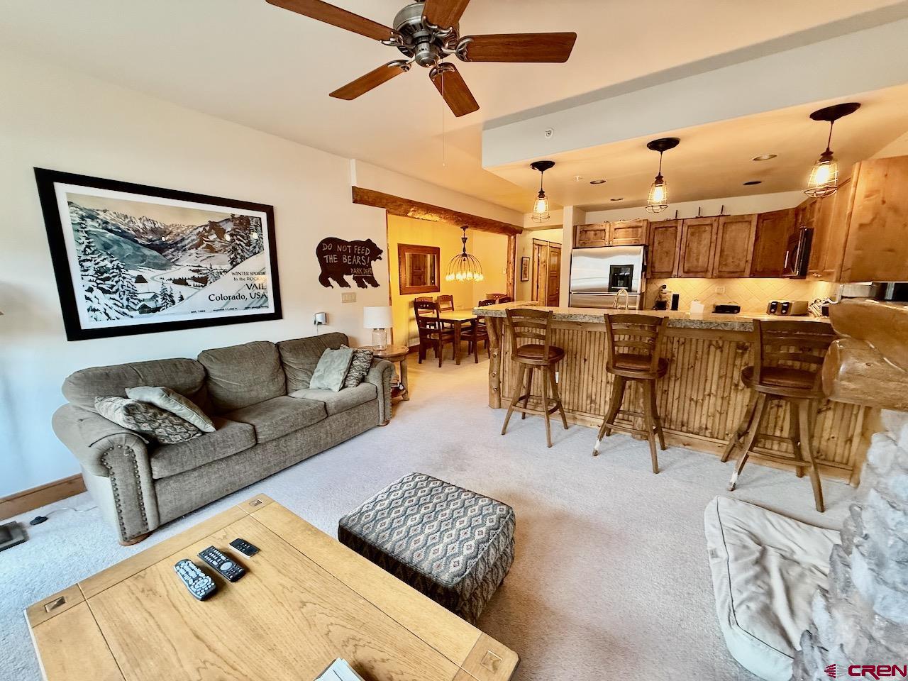 9 Hunter Hill Road, Unit 104 Crested Butte, CO 81225 - Photo 6 of 38 a living room with lots of furniture and a large window