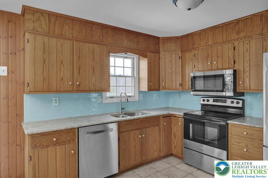 282 Ernst Road Mohrsville, PA 19541 - Photo 13 of 50 a kitchen with stainless steel appliances granite countertop a sink a stove a microwave and cabinets