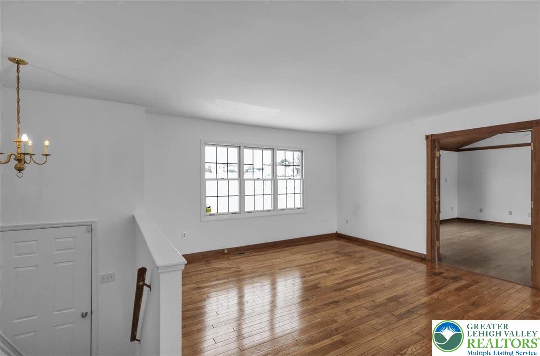 282 Ernst Road Mohrsville, PA 19541 - Photo 6 of 50 an empty room with wooden floor and windows