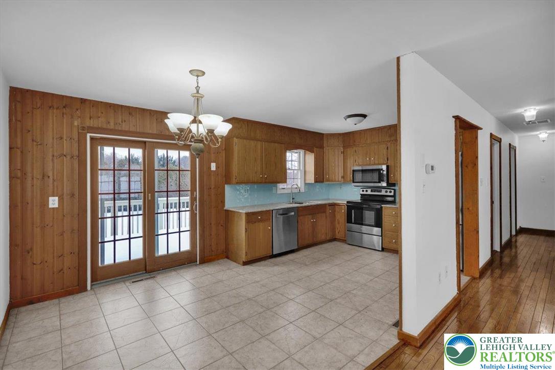 282 Ernst Road Mohrsville, PA 19541 - Photo 10 of 50 a kitchen with granite countertop a refrigerator and a stove top oven
