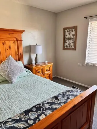 a bedroom with bed and window
