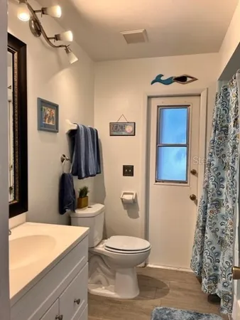 a bathroom with a toilet sink and shower
