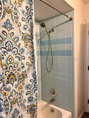 a bathroom with a shower and a sink