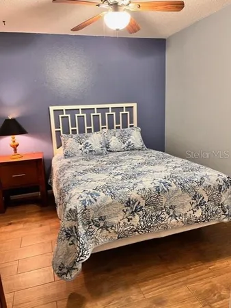 a bedroom with a bed and a night stand
