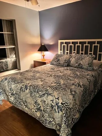 a large bed sitting in a bedroom next to a cabinet