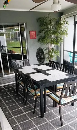 a view of a dinning table and chairs in patio