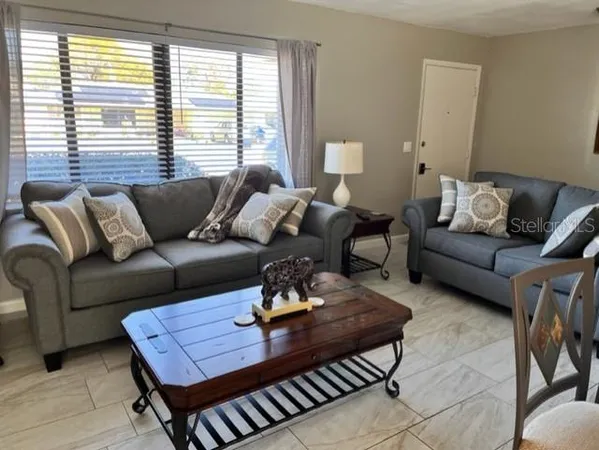 a living room with furniture and a window