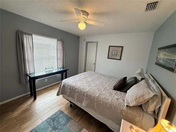 a spacious bedroom with a bed and a chandelier
