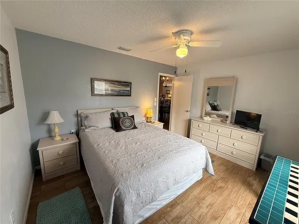 a bedroom with a bed and a chandelier