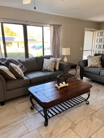 a living room with furniture and a large window