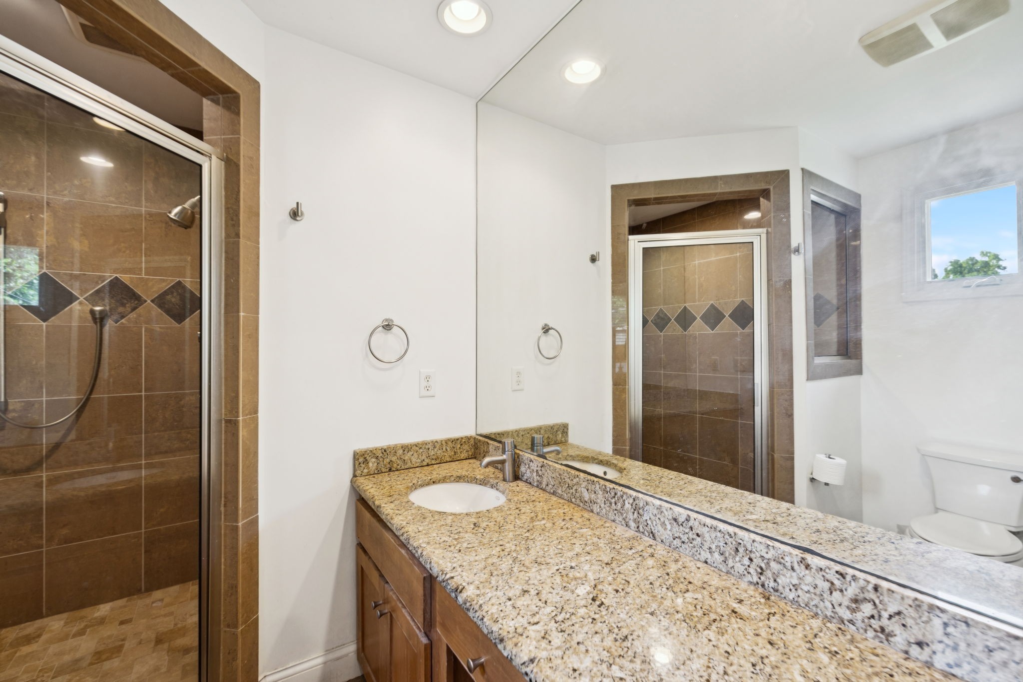 4202 Murphy Road Nashville, TN 37209 - Photo 28 of 34 a bathroom with a granite countertop sink a shower and a mirror