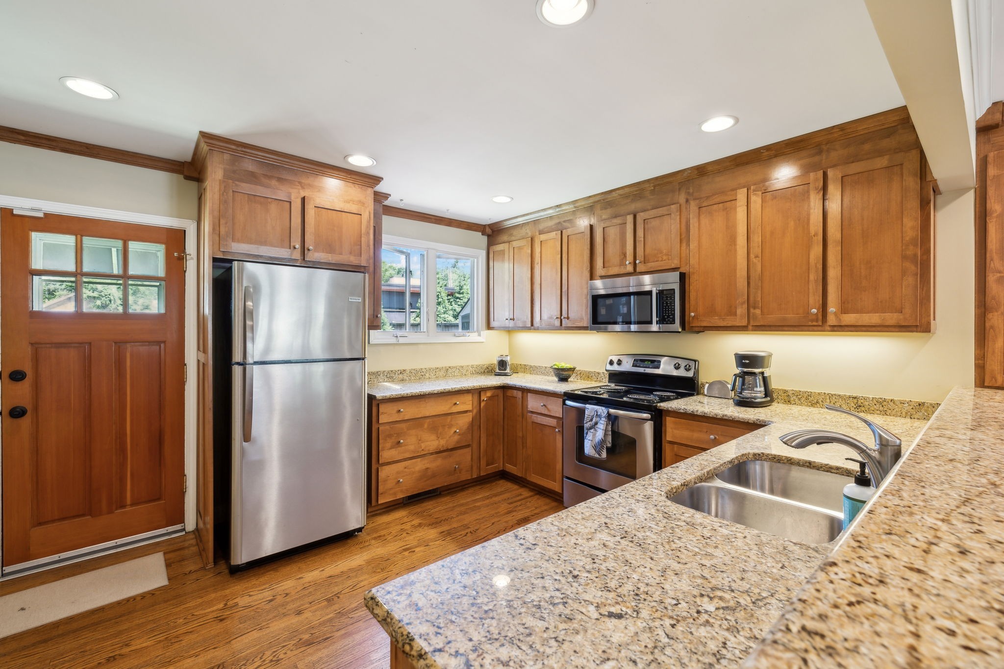 4202 Murphy Road Nashville, TN 37209 - Photo 7 of 34 a kitchen with granite countertop a refrigerator stove top oven and sink