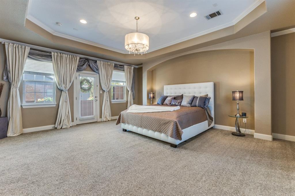 4931 Homer Street Dallas, TX 75206 - Photo 11 of 29 a spacious bedroom with a large bed and a large window