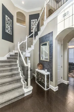 a view of staircase with black white walls
