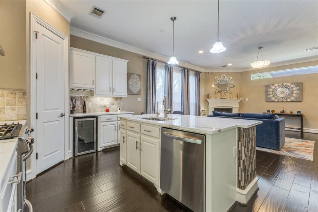 4931 Homer Street Dallas, TX 75206 - Photo 29 of 29 a kitchen with stainless steel appliances granite countertop a stove a sink a refrigerator and white cabinets with wooden floor