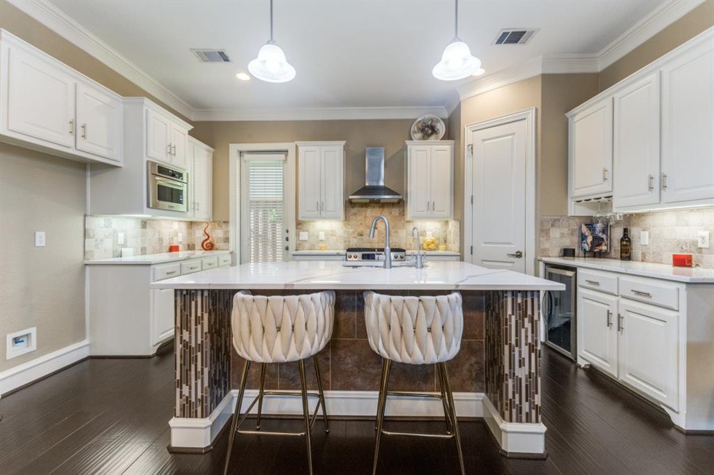 4931 Homer Street Dallas, TX 75206 - Photo 8 of 29 a kitchen with a table chairs stove and cabinets