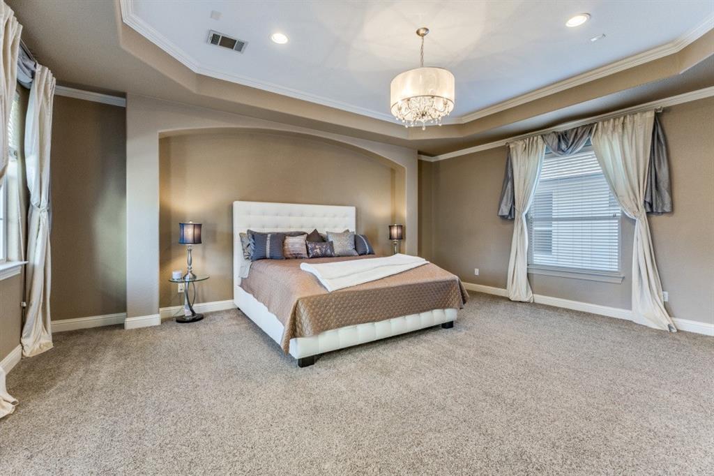 4931 Homer Street Dallas, TX 75206 - Photo 9 of 29 a bedroom with a bed and a chandelier