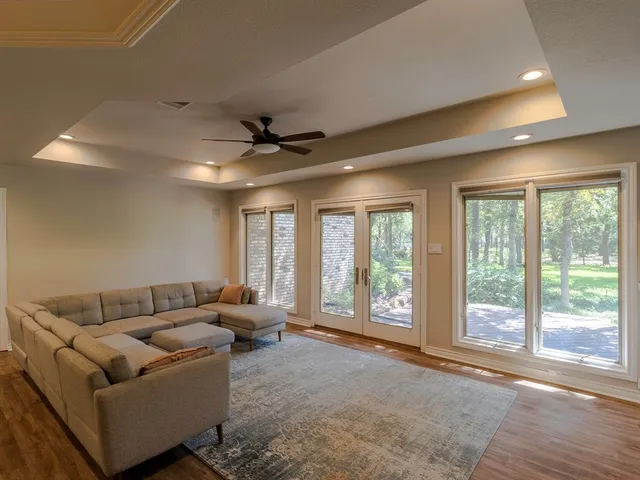 a view of a hallway with wooden floor and staircase