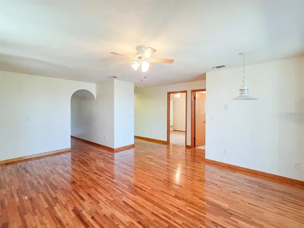 an empty room with closet and fan