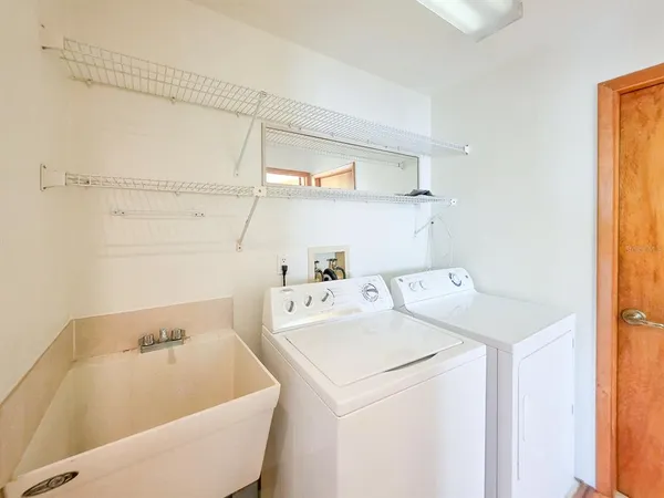 an empty room with closet and a chandelier fan