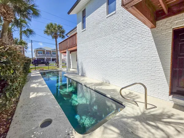 a view of a house with swimming pool and a yard