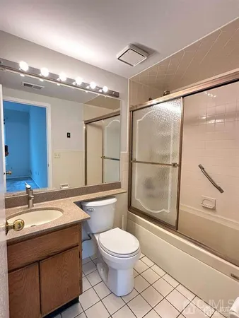 a bathroom with a toilet a sink and a mirror