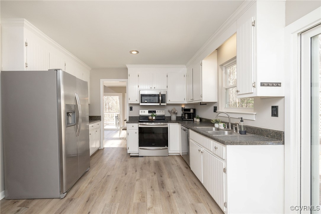 3018 3 Bridges Road Midlothian, VA 23112 - Photo 11 of 30 Kitchen with dark countertops, light wood-type flo