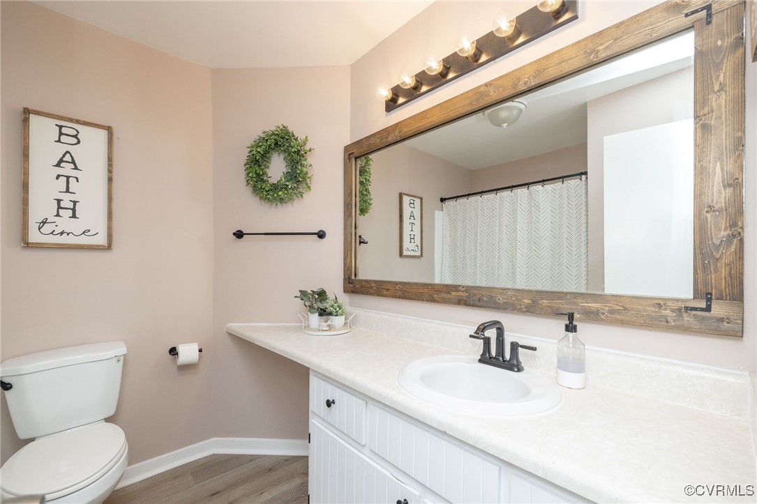3018 3 Bridges Road Midlothian, VA 23112 - Photo 21 of 30 Full bath with toilet, vanity, baseboards, and woo
