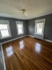 113 Rockland Street, Unit 2 Canton, MA 02021 - Photo 18 of 22 an empty room with wooden floor and windows
