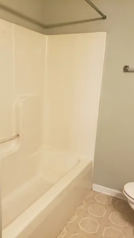 a bathroom with a shower and a toilet
