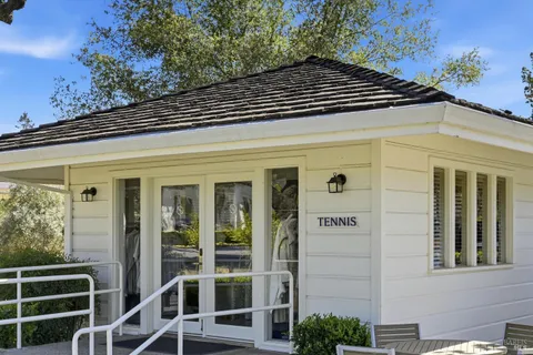 a view of a porch with a table and chairs
