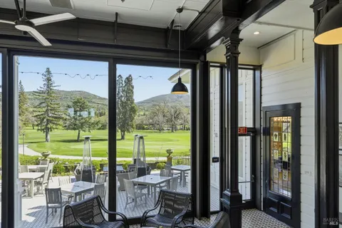 a view of a house with backyard and sitting area