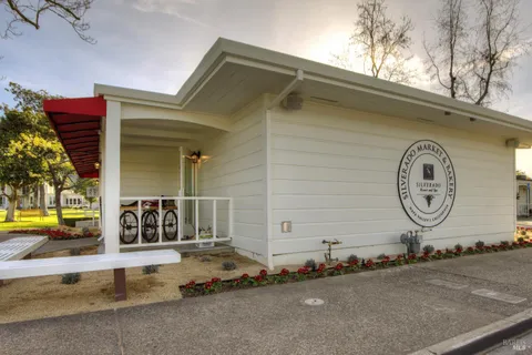 a view of a house with swimming pool and sitting area