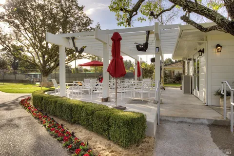 a front view of a house with a yard table and chairs