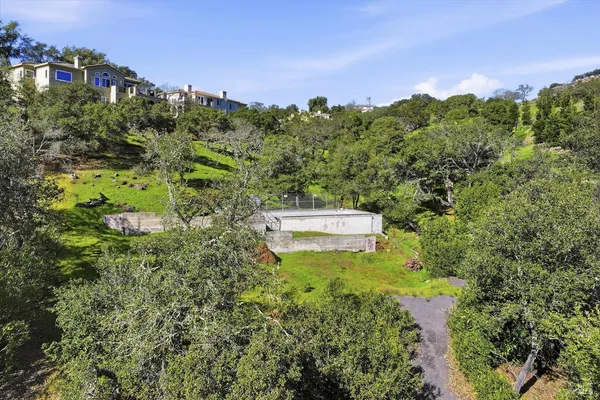 a backyard of a house with lots of green space and mountain view