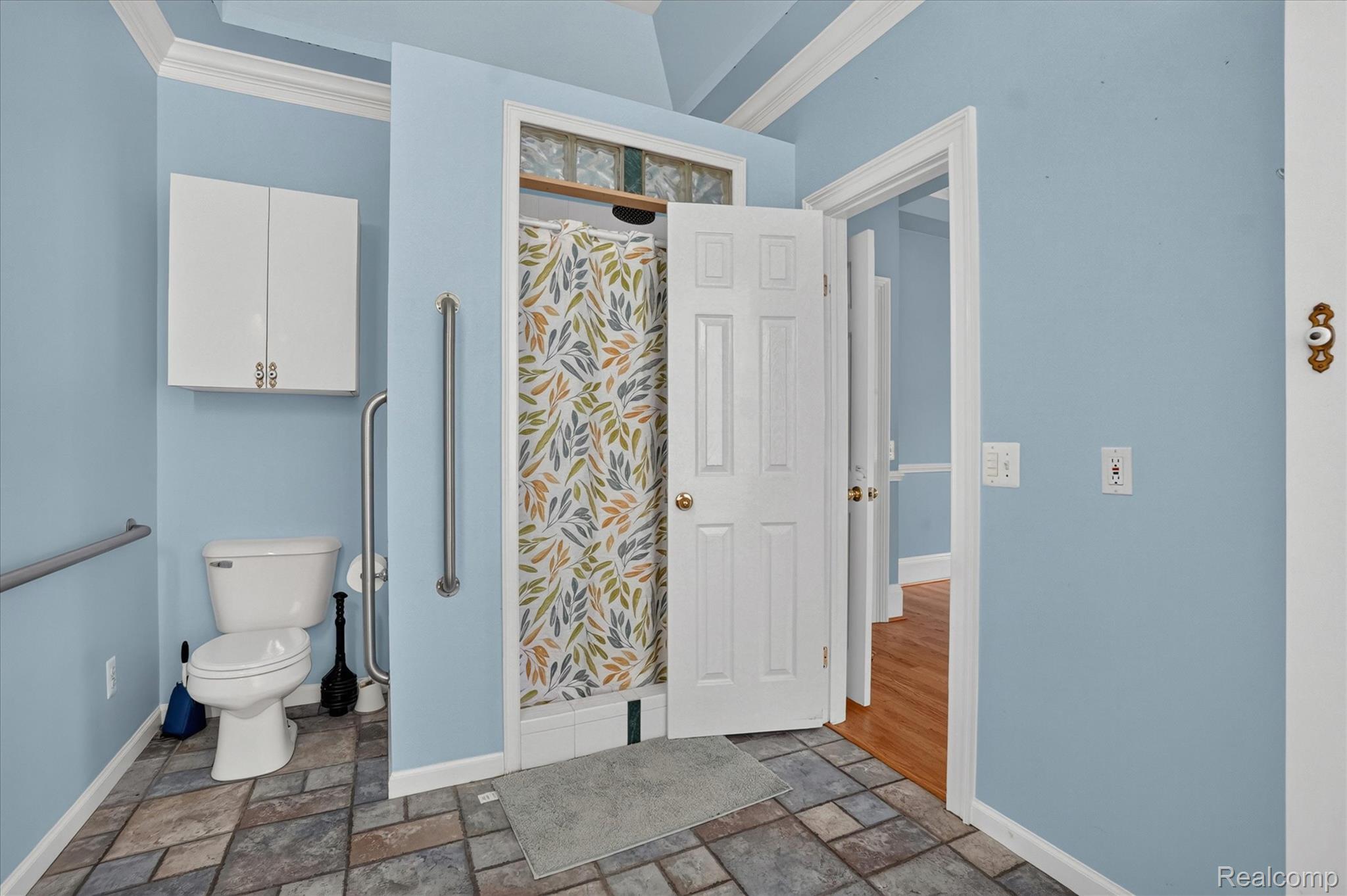 6524 Kelly Road Flushing, MI 48433 - Photo 31 of 47 Bathroom with multi-tone tile flooring, white toilet, and an enclosed shower stall with a decorative shower curtain