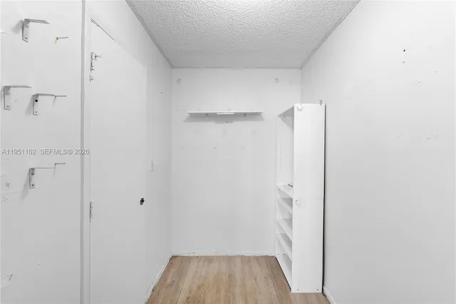 a bathroom with a shower and a hallway