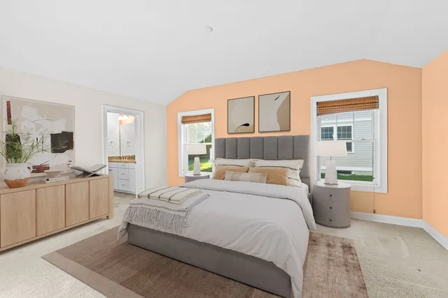 a bedroom with a large bed and a window