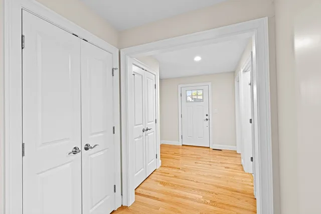 a view of a hallway with wooden floor