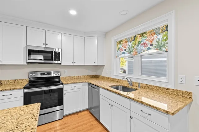 a kitchen with appliances cabinets and a window